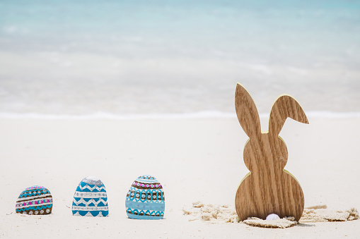 Easter Bunny by the sea with nest and eggs