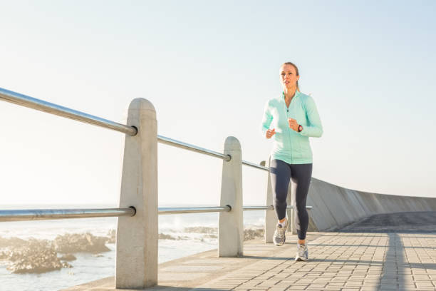 istock Focused fit blonde jogging at promenade 668894904