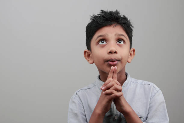 istock Portrait of a boy looks up and thinks 668895426