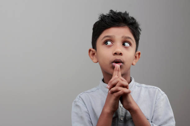 istock Portrait of a boy looks up and thinks 668895804