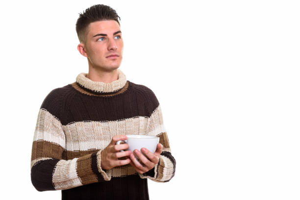 istock Studio shot of young handsome man holding coffee cup while thinking 668895924