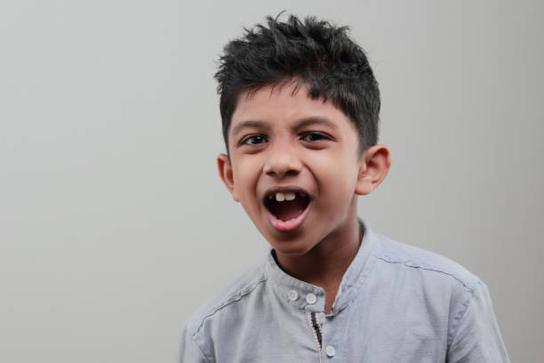 istock Portrait of a boy with a cheering face 668898950