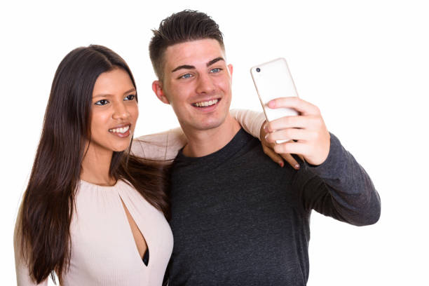 istock Happy young couple smiling while man taking selfie together with girlfriend 668901204