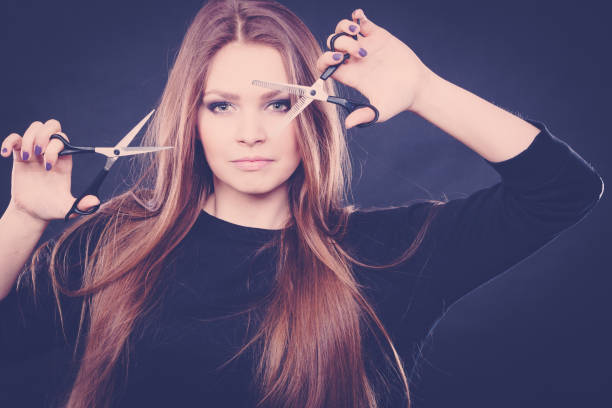 istock Female hairstylist barber with scissors. 668902788