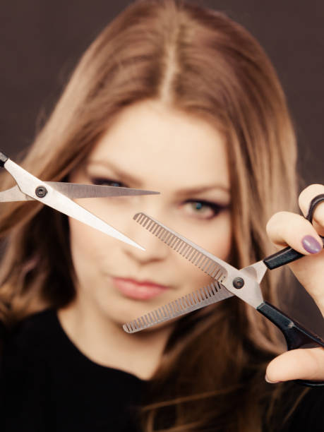 istock Professional elegant female barber with scissors. 668908226