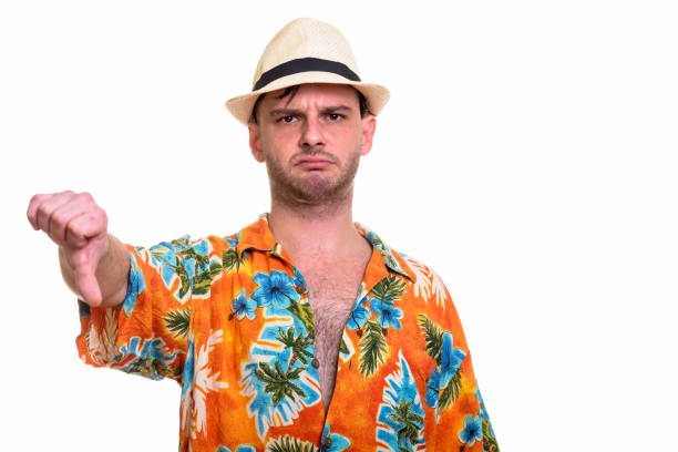 istock Studio shot of young tourist man looking upset while giving thumb down 668908644