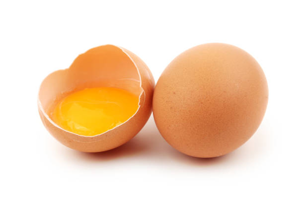 istock Group of brown raw eggs, one is broken, isolated white 668916210