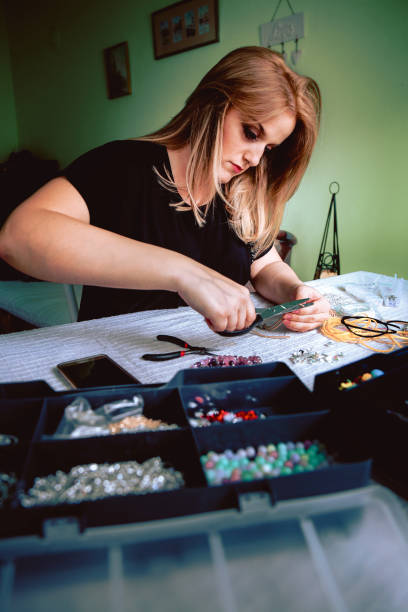 istock Young woman crafting jewelry 668923372