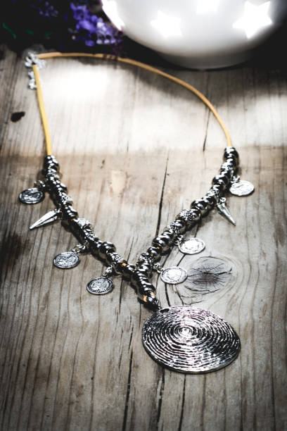 istock Designer Silver Necklace on wooden table 668924212