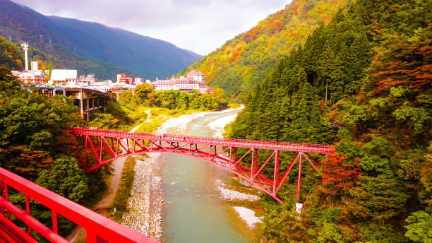 istock Japanese red bridge in Kurobe gorge 668926408