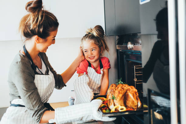 istock Mother taking the dinner out of the oven 668930210