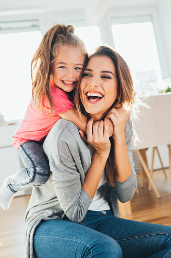 Happy mother and daughter playing together.