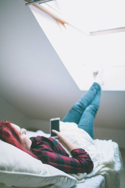 istock Relaxed woman at home reading a text message 668930594
