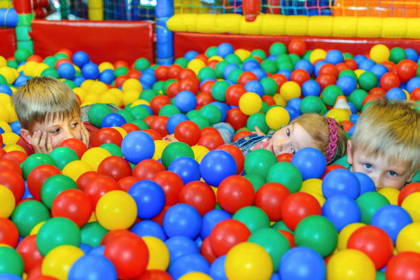 istock Cute kids in a sponge ball pool 668933138