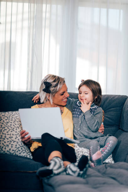 istock Mother and daugther using online entertainment and spending time together 668934626