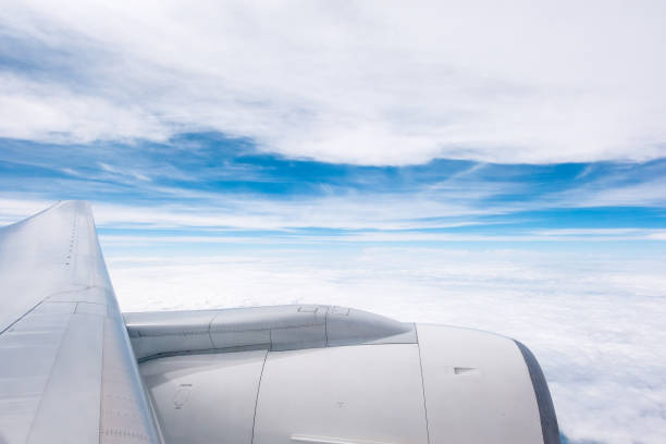 istock blue sky and white cloud view from windows of airplane 668938226