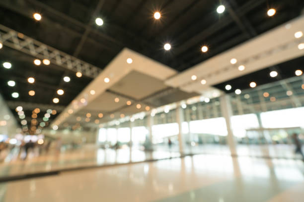 Public event exhibition hall, blurred bokeh defocused background, business trade show or modern interior architecture concept Public event exhibition hall, blurred bokeh defocused background, business trade show or modern interior architecture concept sports venue stock pictures, royalty-free photos & images