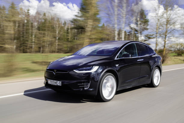 Tesla Model X P90D Minsk, Belarus - April 7, 2017: Tesla Model X P90D on a highway. Model X is the fastest and most capable SUV in history. It accelerates from zero to 60 miles per hour in 3.2 seconds. Tesla Model X equipped with autopilot system matches speed to traffic conditions, keeps within a lane, automatically changes lanes without requiring driver input. tesla model x stock pictures, royalty-free photos & images