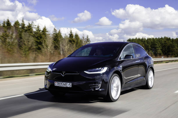 Tesla Model X P90D Minsk, Belarus - April 7, 2017: Tesla Model X P90D on a highway. Model X is the fastest and most capable SUV in history. It accelerates from zero to 60 miles per hour in 3.2 seconds. Tesla Model X equipped with autopilot system matches speed to traffic conditions, keeps within a lane, automatically changes lanes without requiring driver input. tesla model x stock pictures, royalty-free photos & images