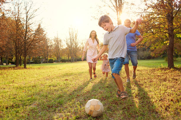 istock Family playing with a ball in the park 668944206