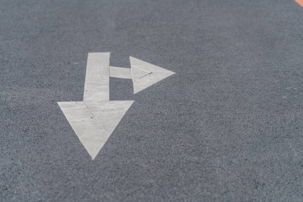 Full frame shot of white arrow symbol on road.