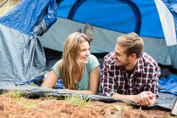 istock Young pretty hiker couple lying in a tent 668947656