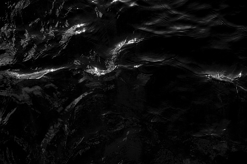 Dark rippling water surface from above. Lake Windermere, Cumbria, England.