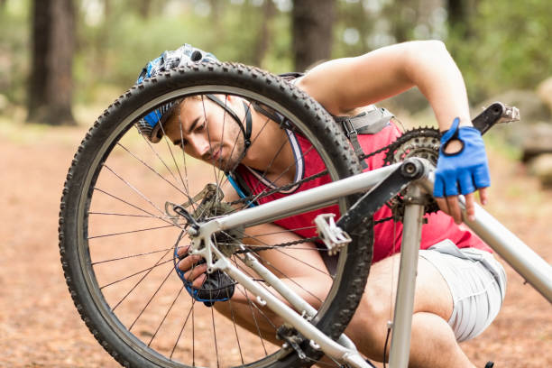 istock Happy handsome biker repairing bike 668955816