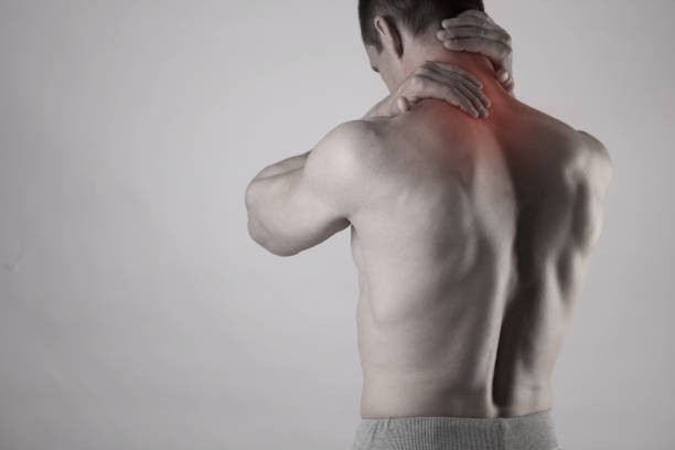 istock Muscular Man suffering from back and neck pain. Incorrect sitting posture problems Muscle spasm, rheumatism. Pain relief, ,chiropractic concept. Sport exercising injury 668973376