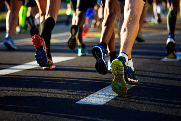 istock Runners legs from behind on the road 668976828