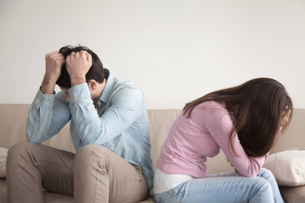 istock Stressed couple sitting back to back, family and relationships problems 668986498