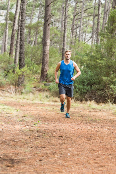 young happy jogger running - running jogging footpath cross country running imagens e fotografias de stock