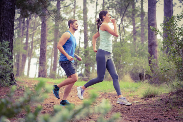 happy joggers running - running jogging footpath cross country running imagens e fotografias de stock