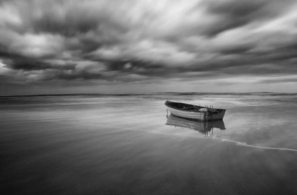 istock lonely boat on calm sea 668990158