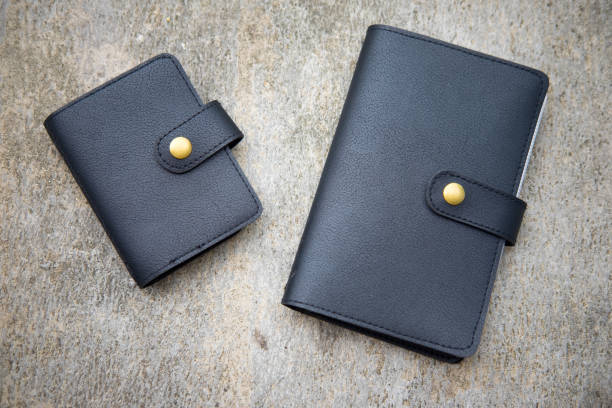 istock Two male black leather wallet on concrete background 669002578