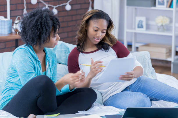 istock Young women work on something in a dorm room 669003258