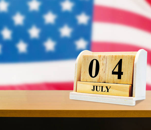 istock Cube shape calendar for July 04 on wooden tabl 669005512