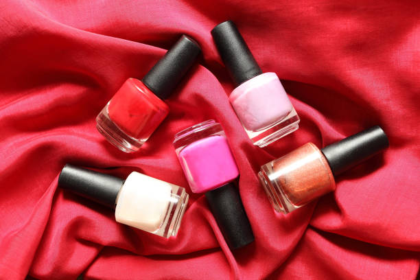 istock Colorful nail polish on red background 669005784