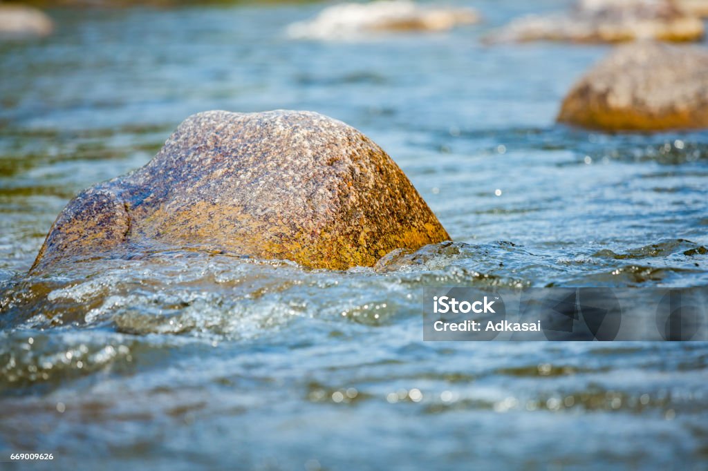 Close-up of stone with water rapids on the river, at travel attraction Take photo real time candid shot in natural river Backgrounds Stock Photo