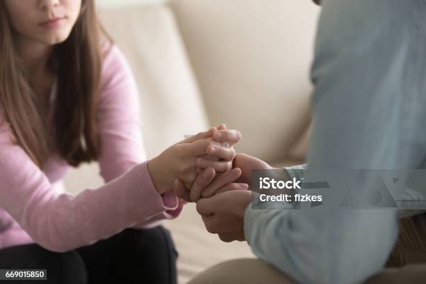 Closeup Of Man Holding Crying Woman Hands Compassion And Comfort Stock Photo - Download Image Now