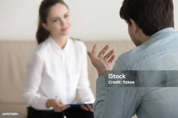 Female Psychologist Consulting Male Patient Job Interview Business Meeting Stock Photo - Download Image Now