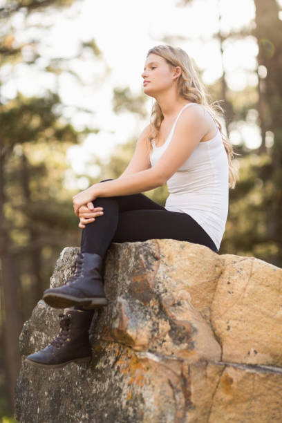istock Young jogger sitting on a rock and looking away 669021412