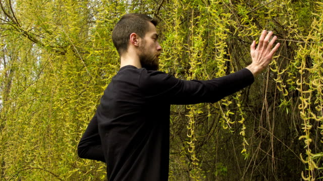 Young man practicing wing chun in the forest