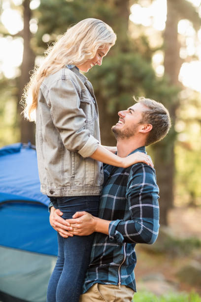 istock Young happy camper holding his smiling girlfriend 669022172