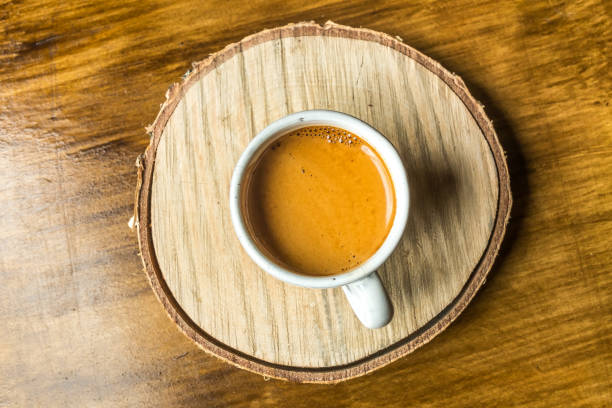 istock White cup of coffee on a wooden stand 669022600