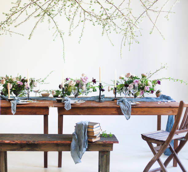 istock Bouquets of pink flowers on a table set for dinner with candles 669025456