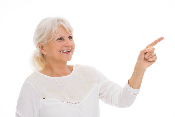 istock Senior woman pointing 669025702