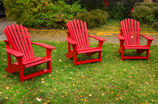 istock Red Adirondack Chairs in a Lawn 669034912