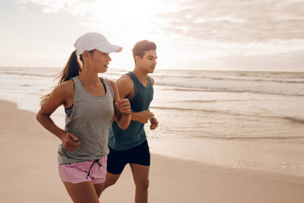 istock Fitness couple running at beach 669038100