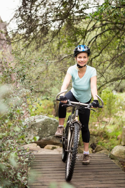 istock Smiling fit woman taking a break on her bike 669044040
